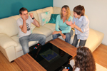Family playing on the Dual arcade coffee table
