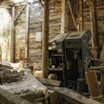 abandoned arcades machines in a barn