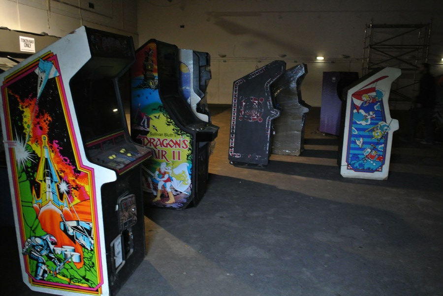 collection of arcade machines in a warehouse