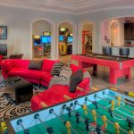 large games room with red sofa pool table and football